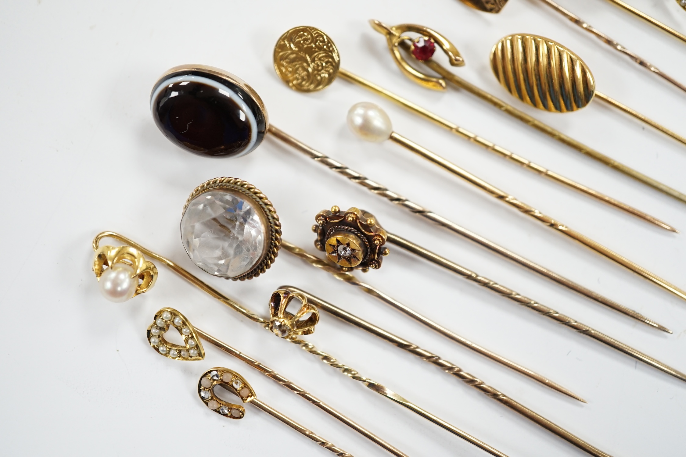 Fifteen assorted mainly early 20th century yellow metal and gem set stick pins, including diamond, seed pearl and banded agate, gross weight 23.1 grams.